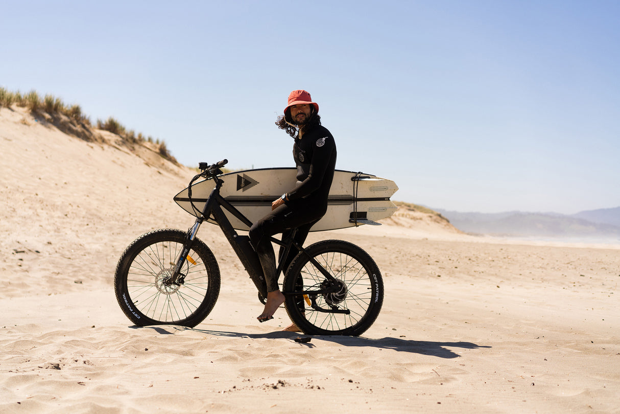 Surface 604 Shred Hardtail eMTB on beach being ridden by surfer.