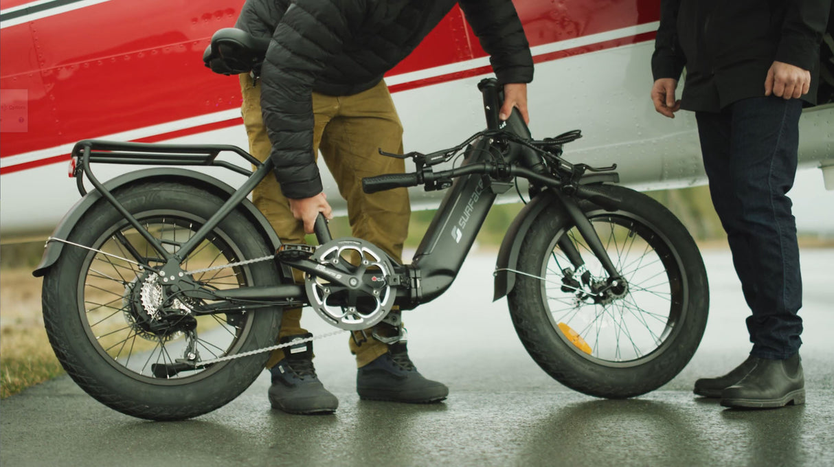 SURFACE604 - Twist Low Step 500W Folding being folded in front of a plane.
