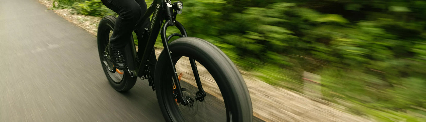 Person riding a Surface604 fat tire eBike on path 