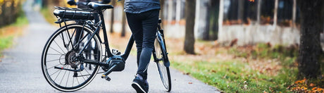 Individual walking next to her eBike 