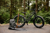Surface 604 Boar Explorer Fat-Tire eBike beside spear fishing equipment.