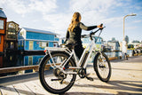 Surface 604 Rook Low-Step Commuter eBike being pushed on pier.