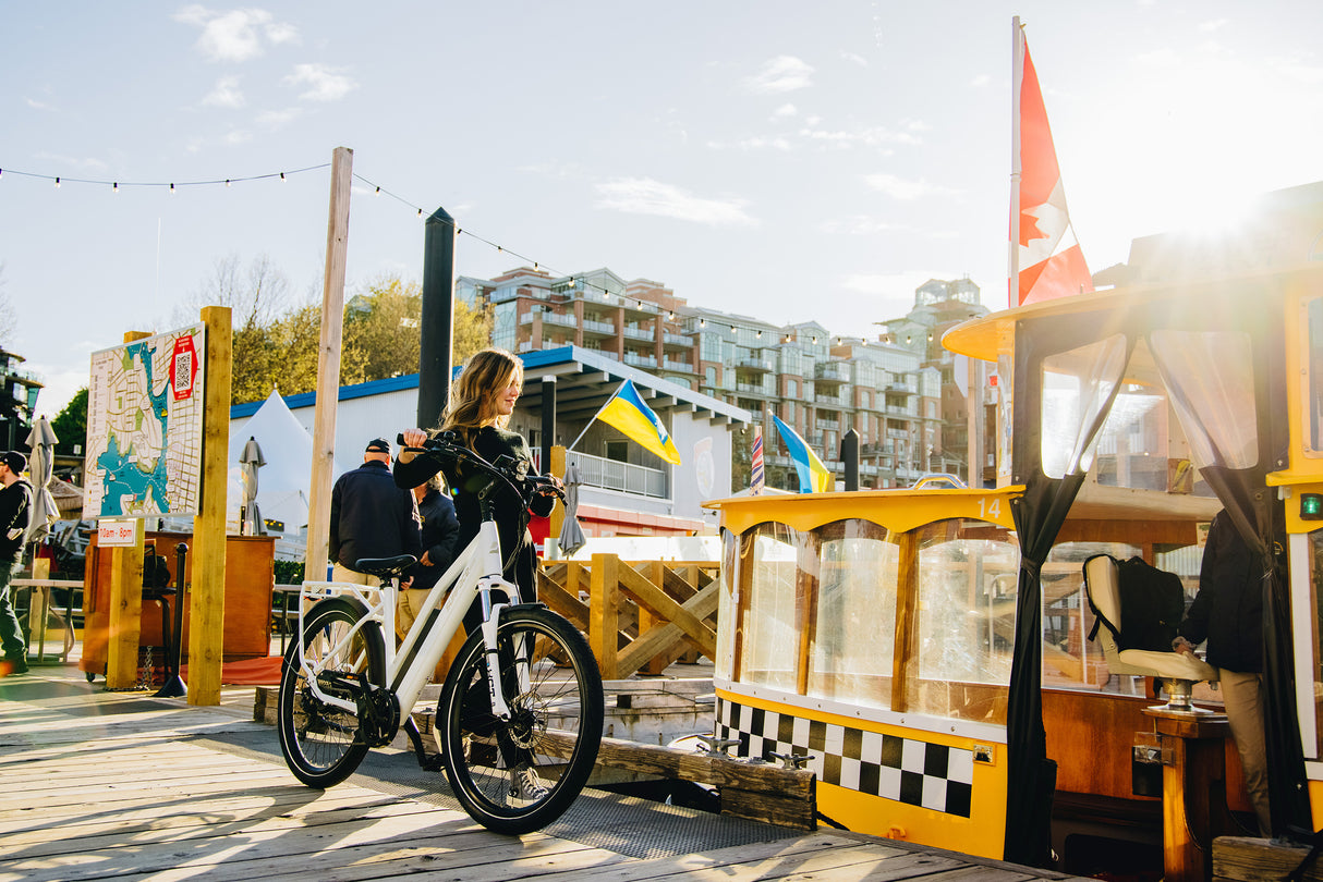 Surface 604 Rook Low-Step Commuter eBike on pier in front of water taxi.