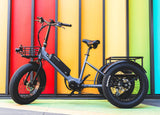 Surface 604 Trio Folding eTrike in front of multi-color wall.